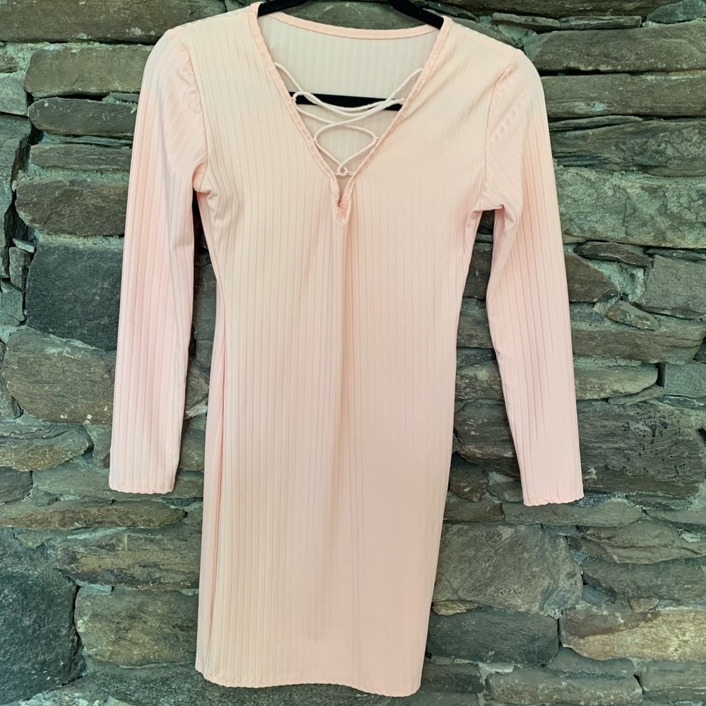 Tight pastel pink ribbed dress and ties on the top